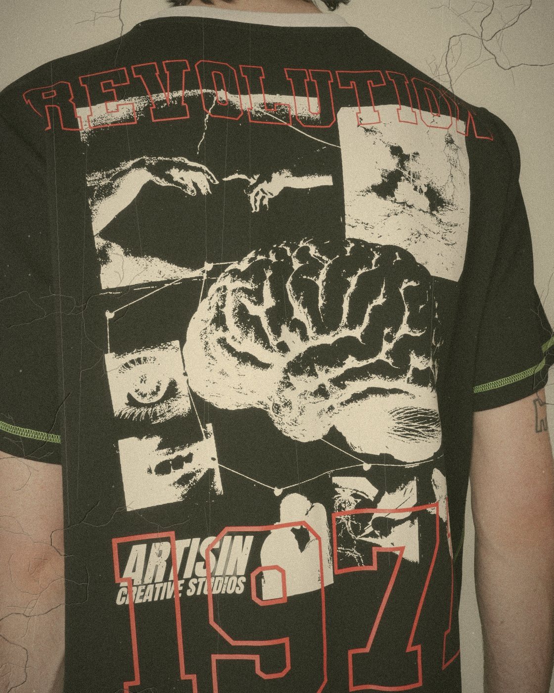 Collage print on the back of a black tee with 1971 and Creative Studios